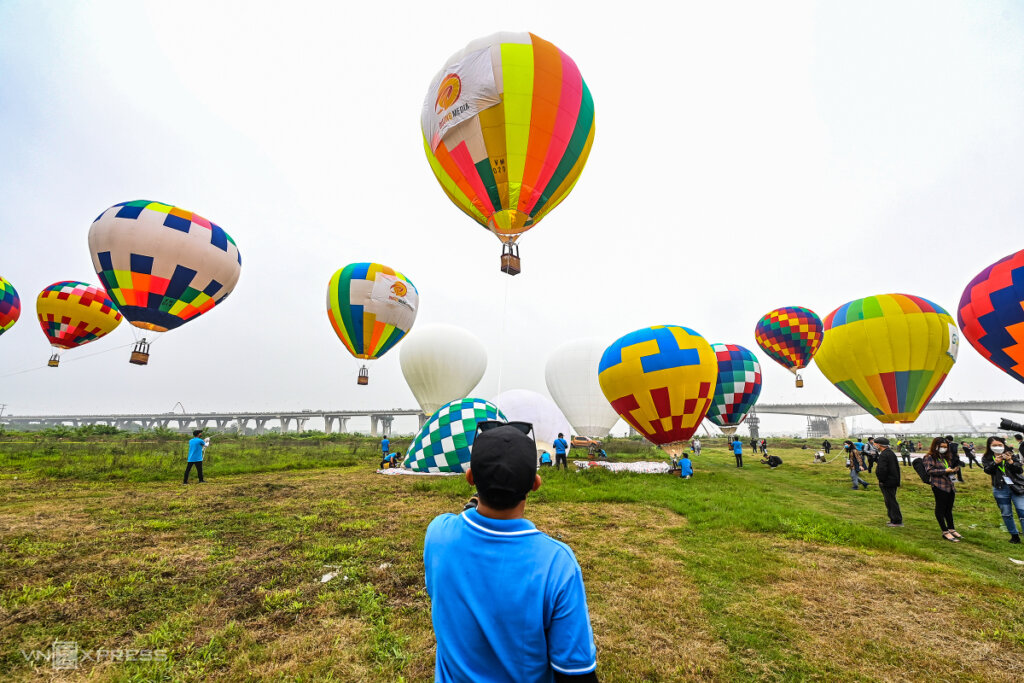 dozens of hot air balloons fly over hanoi
